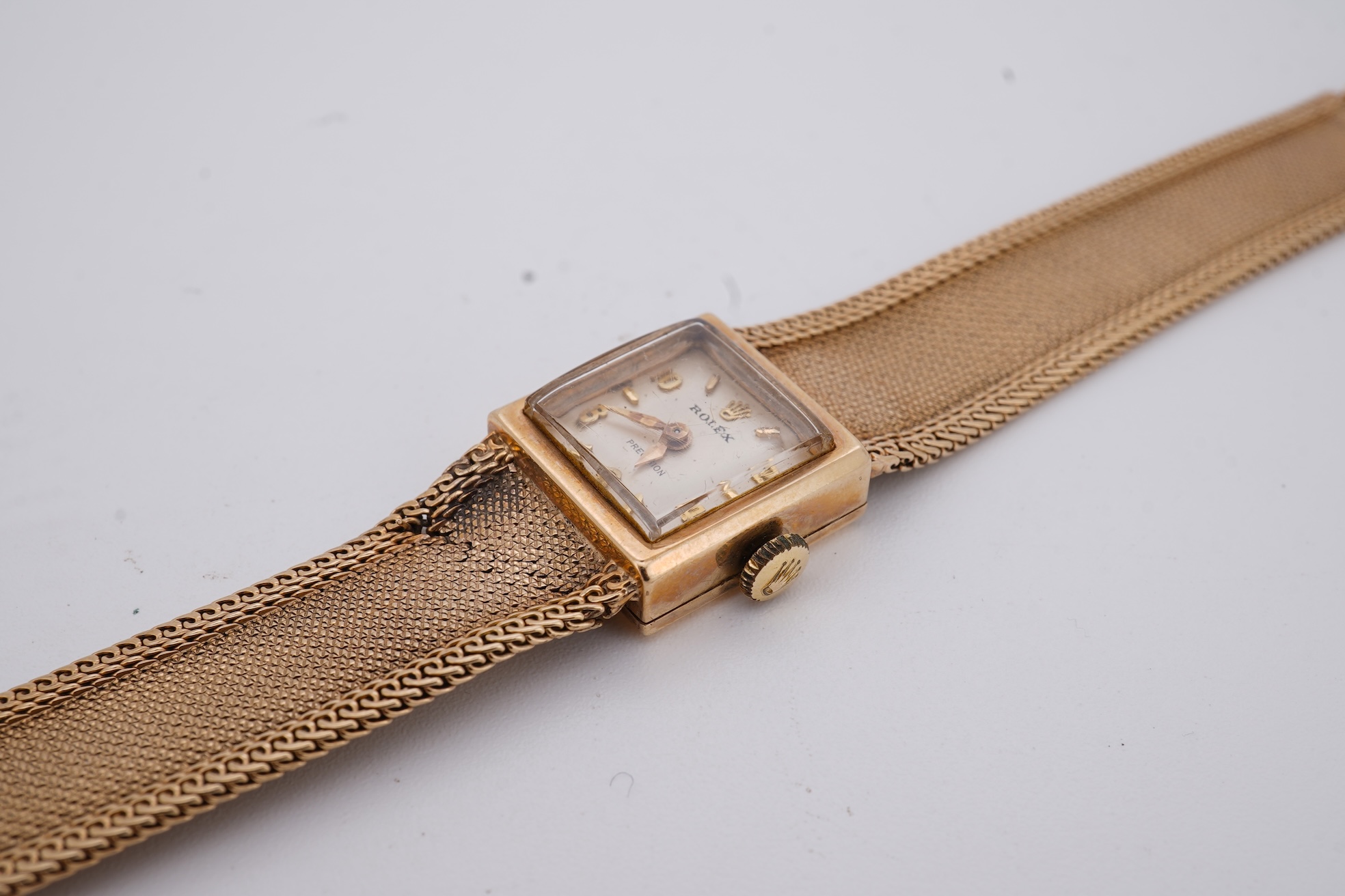 A lady's 1960's 9ct gold Rolex Precision manual wind wrist watch, with square dial, on an integral 9ct gold bracelet, the clasp with Rolex crown, overall length 15cm, gross weight 22 grams (bracelet a.f.)